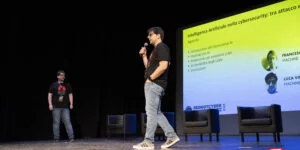 Immagini dello speech di Francesco Conti, Luca Vinciguerra e Salvatore Ricciardi - Tutti Machine Learning Engineer - del gruppo AI di Red Hot Cyber , dal titolo "Intelligenza artificiale nella cybersecurity: tra attacco e difesa".